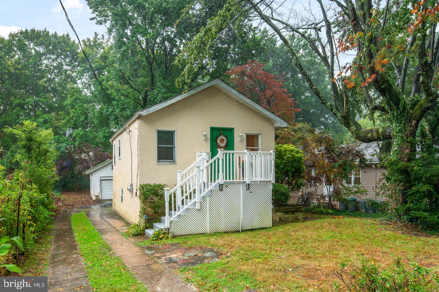 a front view of house with yard and trees around