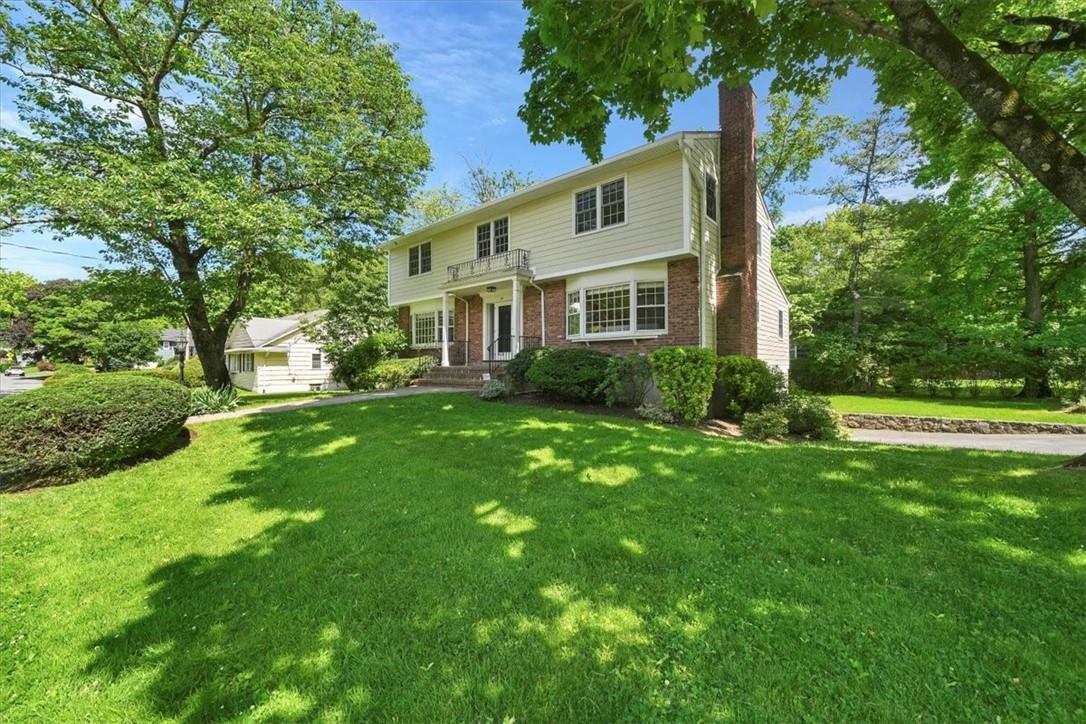 a front view of house with yard and green space