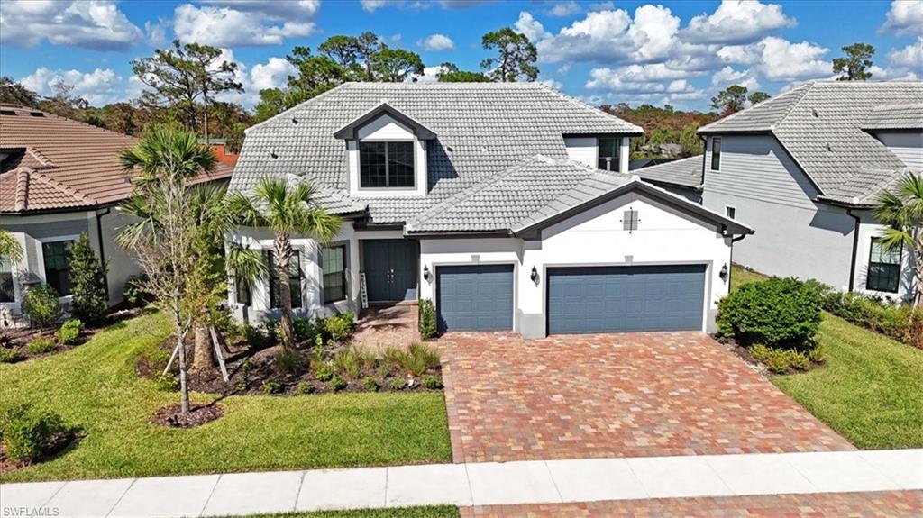 a front view of a house with a yard and garage