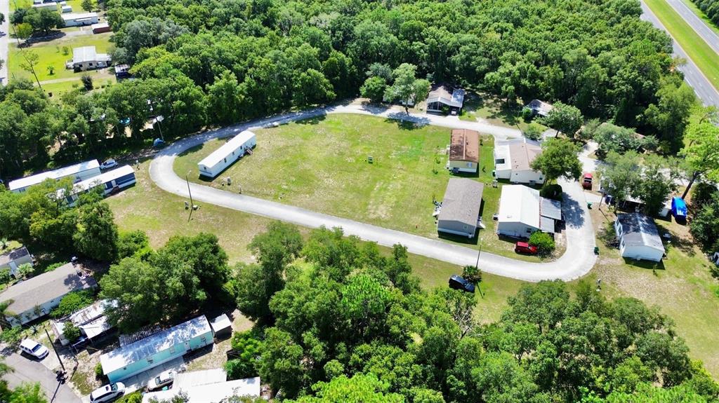 an aerial view of a house with a yard and swimming pool