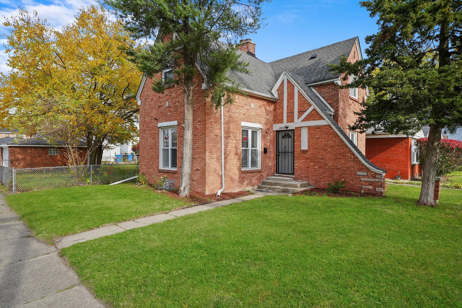 a front view of house with yard and green space