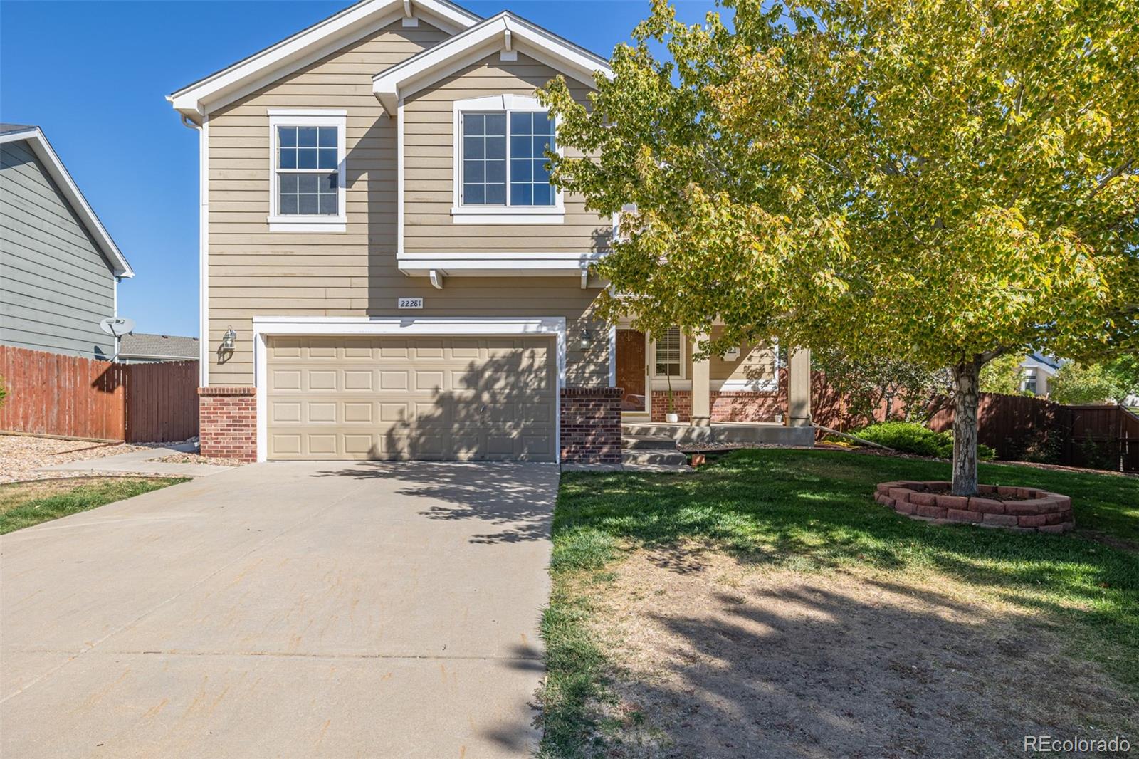 a view of a house with a yard and a garage