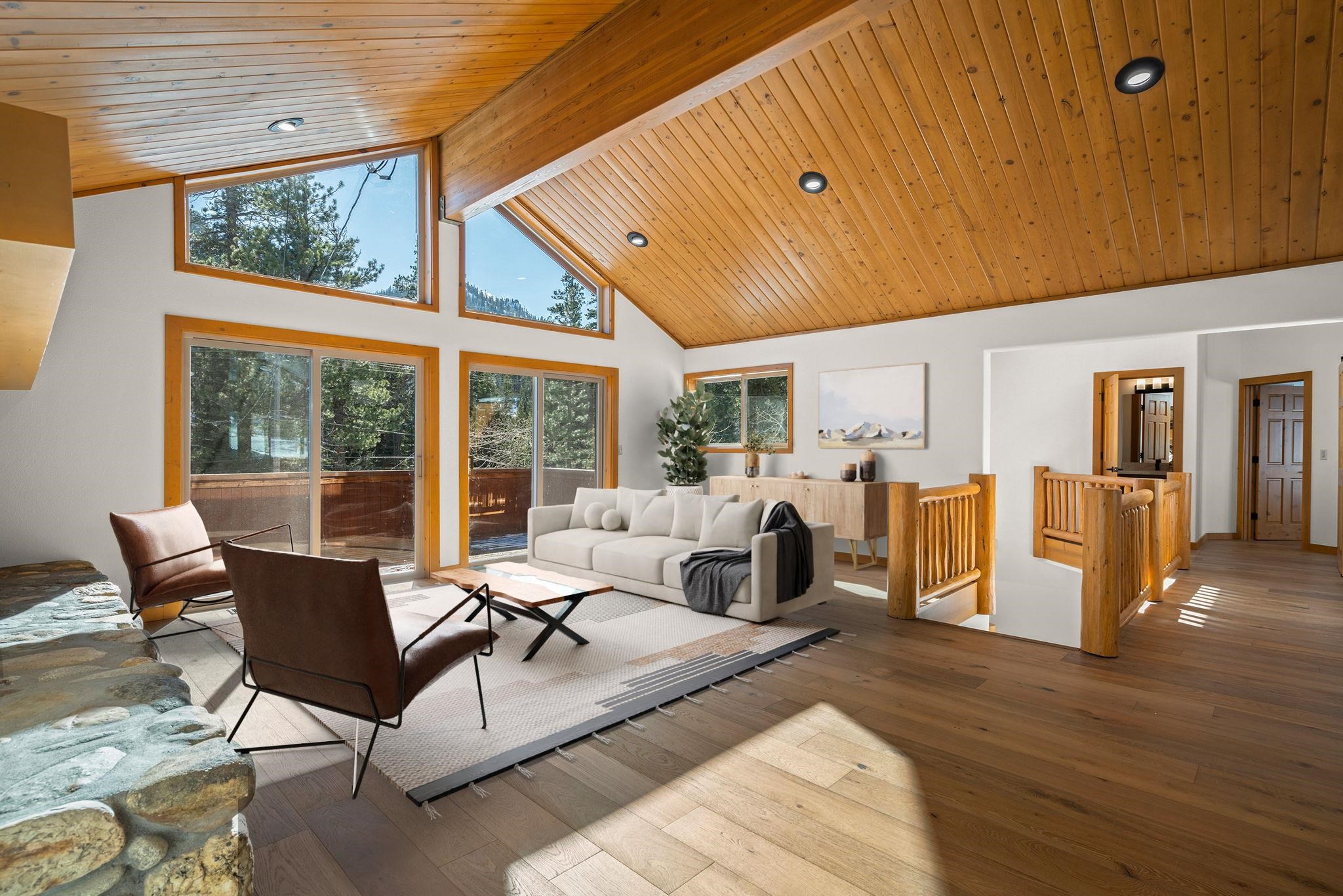 a living room with furniture large window and wooden floor