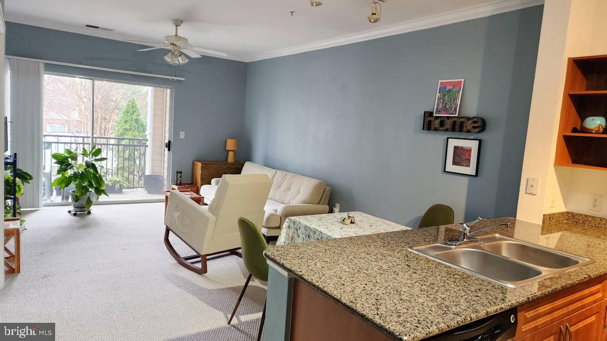 a living room with granite countertop furniture and a wooden floor