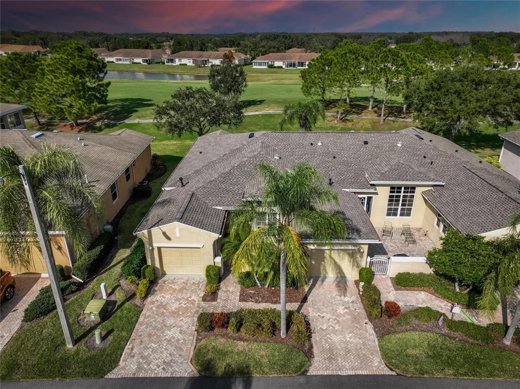 an aerial view of a house with a yard large tree and a yard