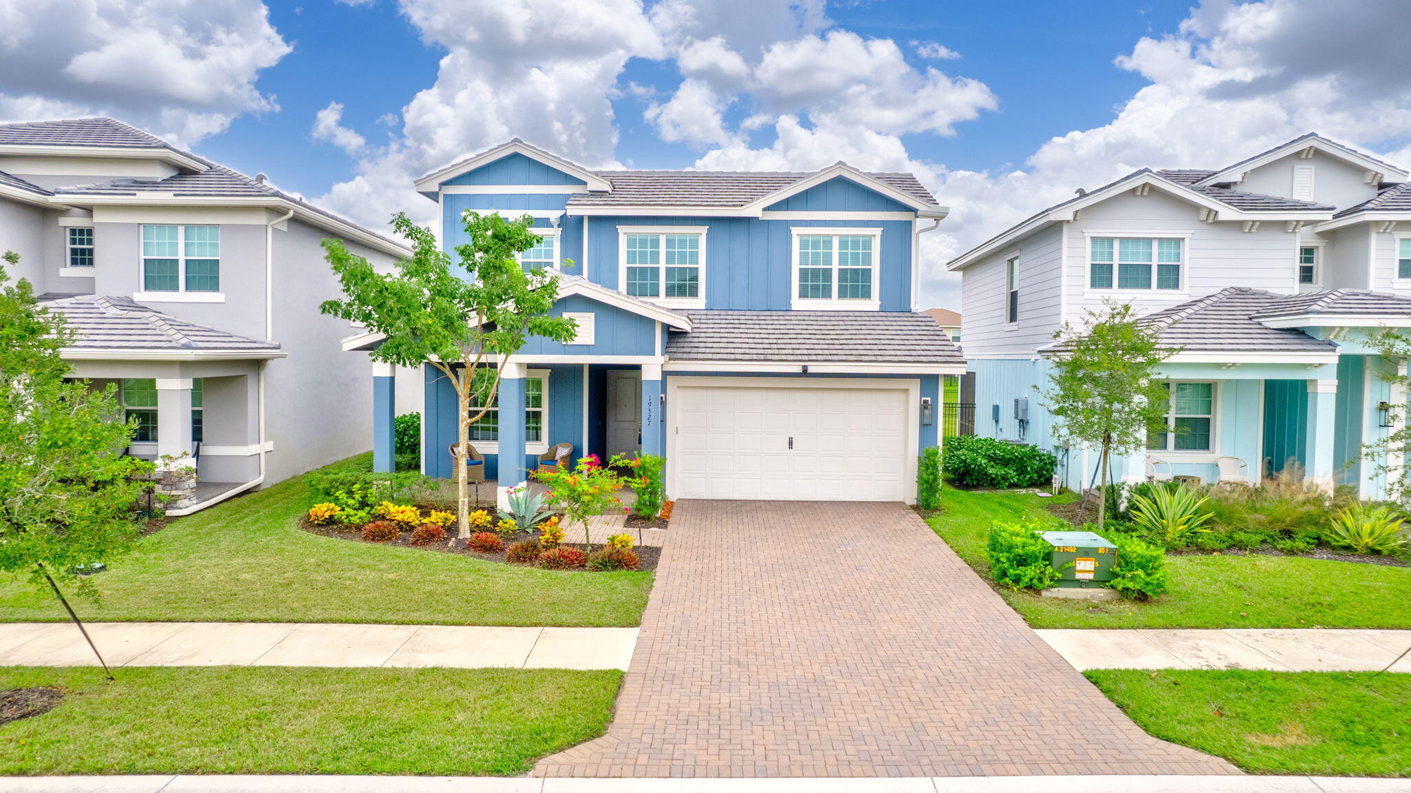 a front view of a house with garden