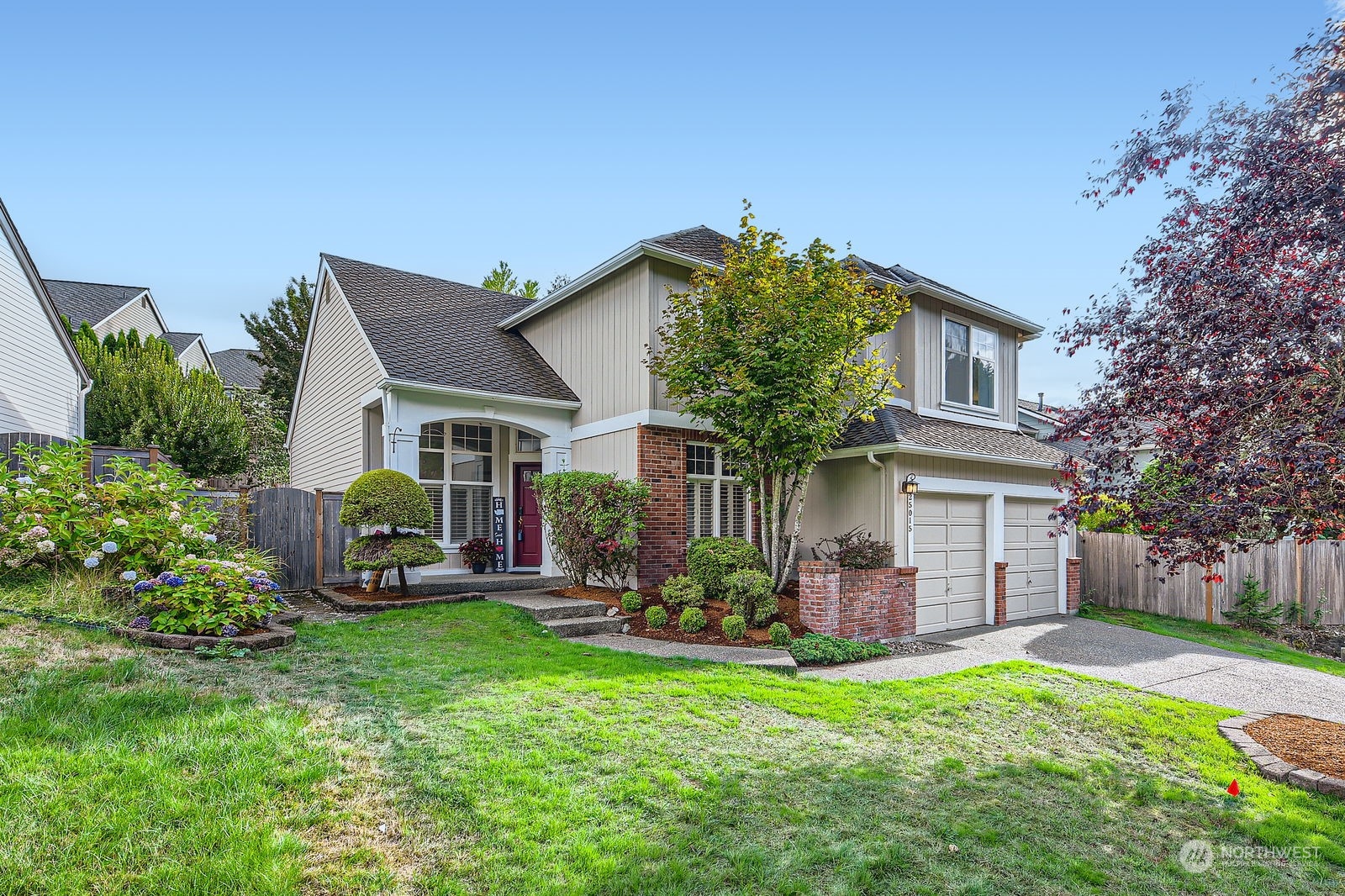 a front view of house with a garden and patio