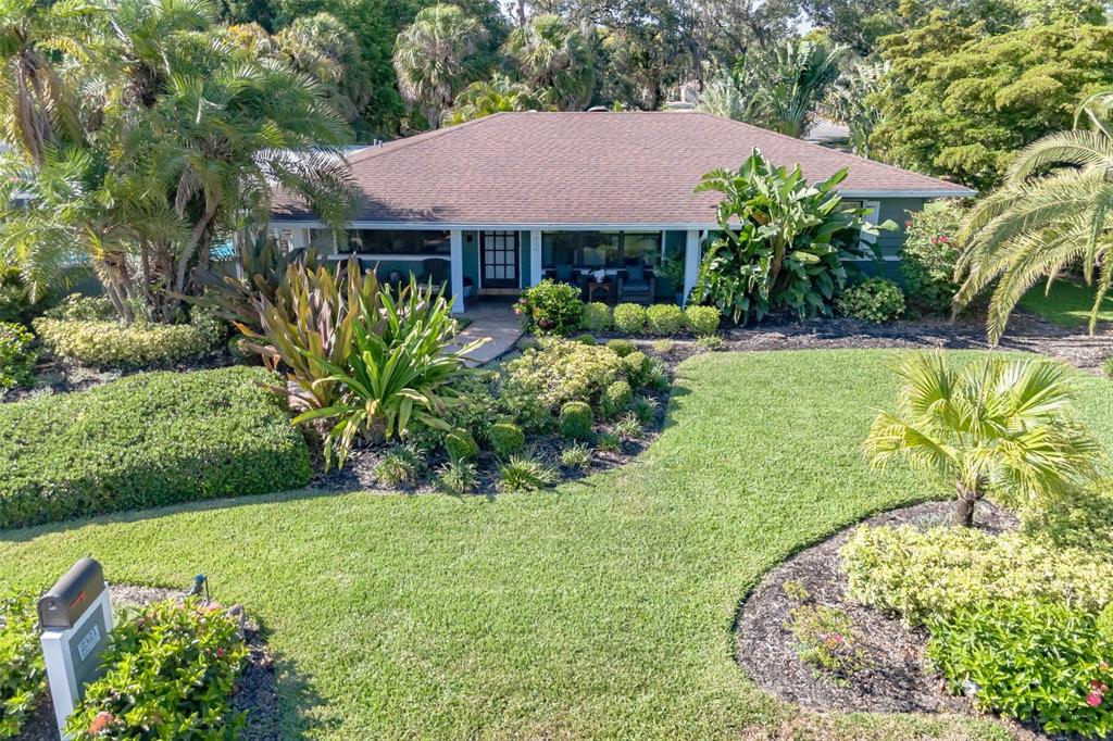 a front view of a house with a garden