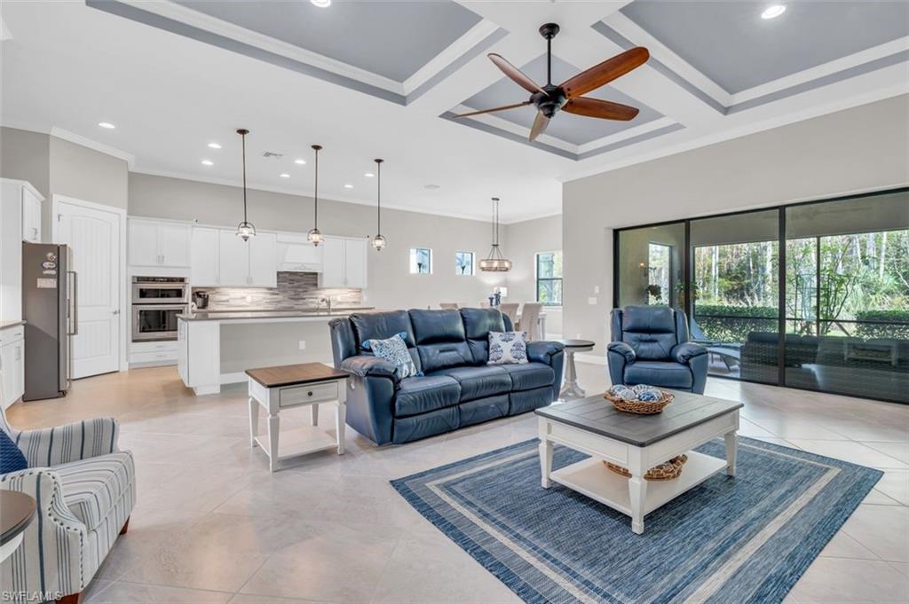 a living room with furniture a ceiling fan and a rug