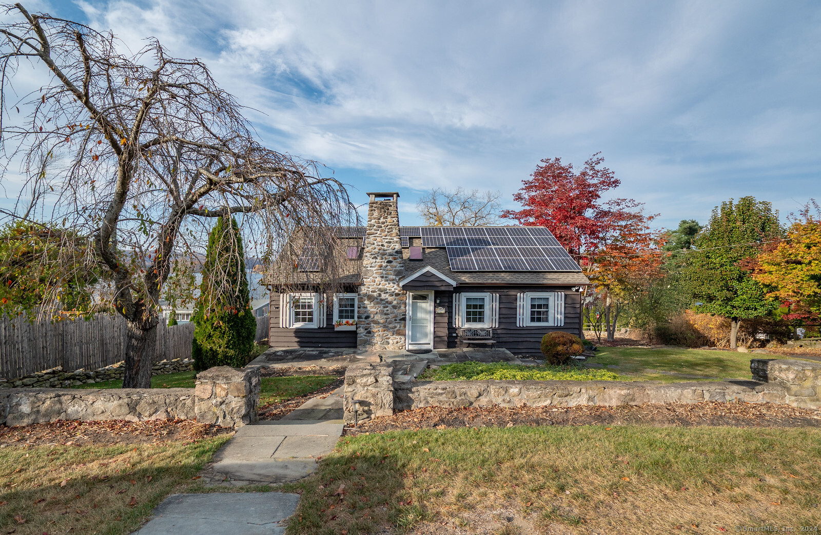 a front view of a house with a yard and a garage