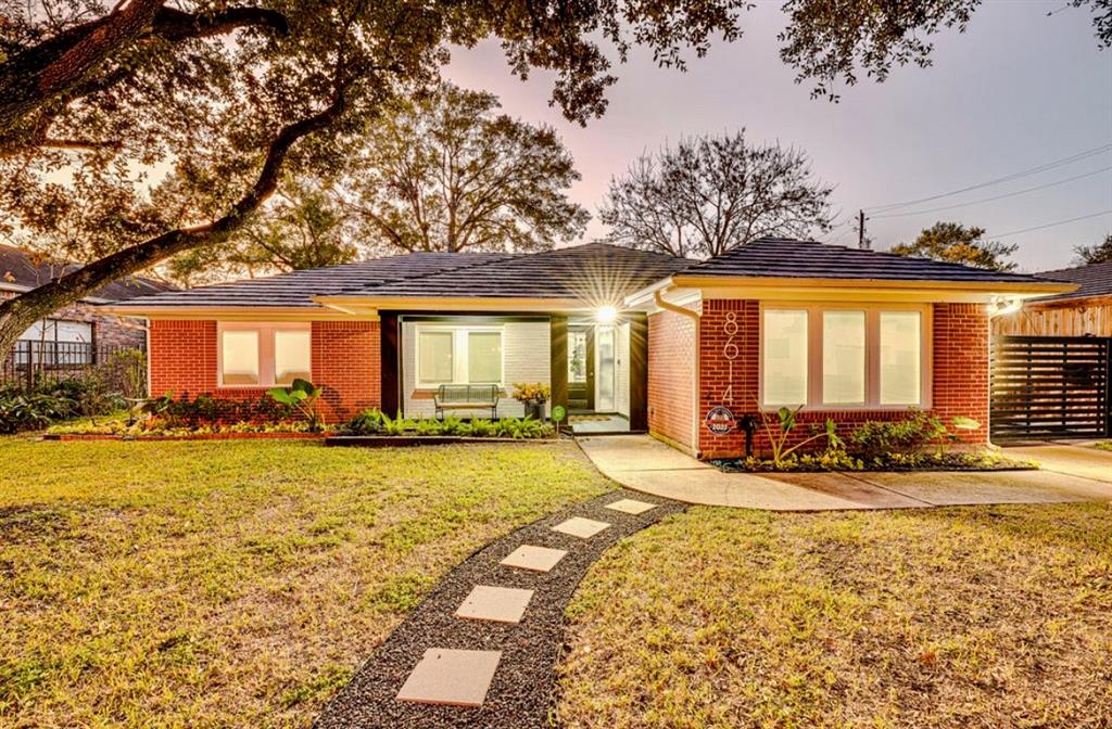 Beautiful curb appeal with Mature Trees and a Stone Path to the entry way of this Charming Home.