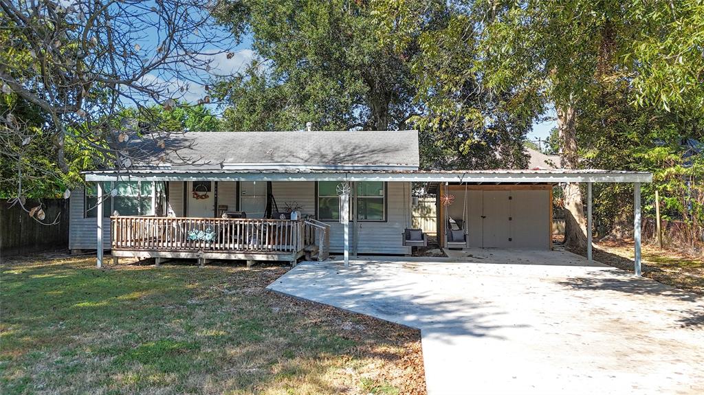 a front view of a house with a yard covered with trees