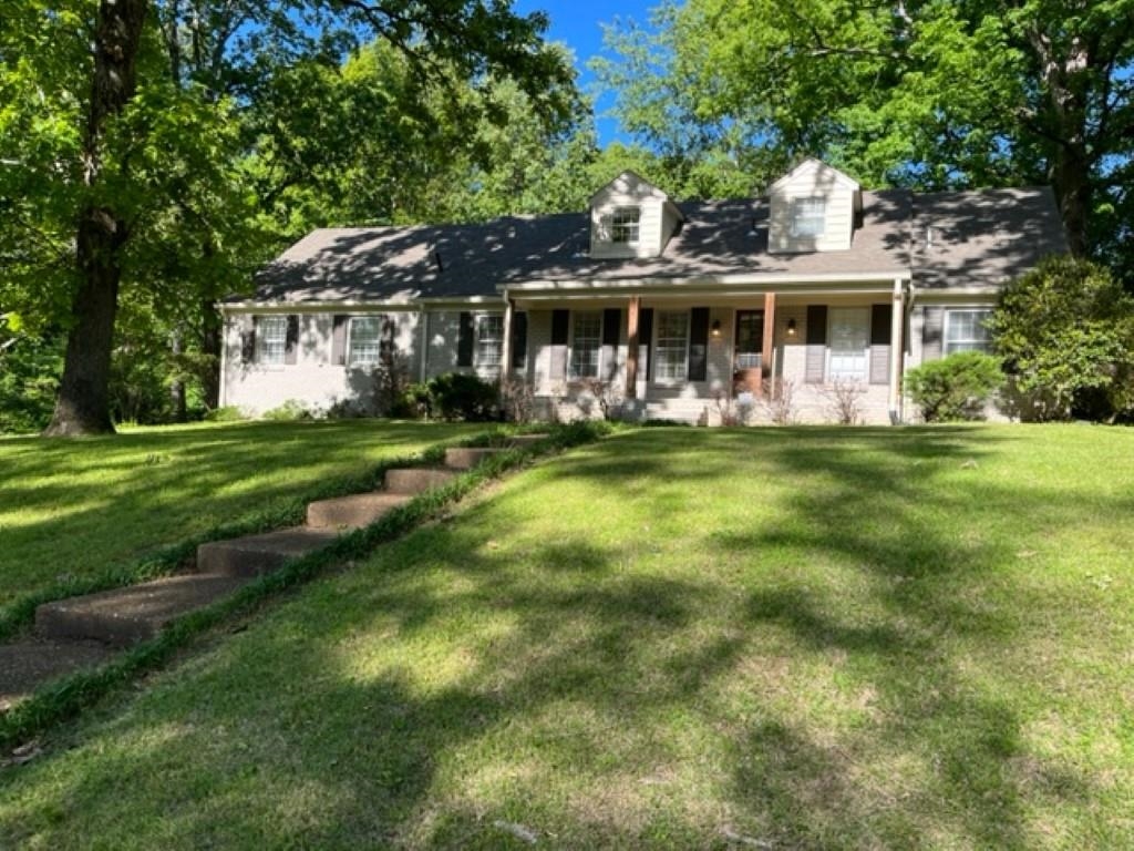 a front view of a house with a garden