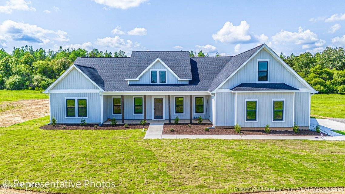 a front view of house with yard outdoor seating and green space