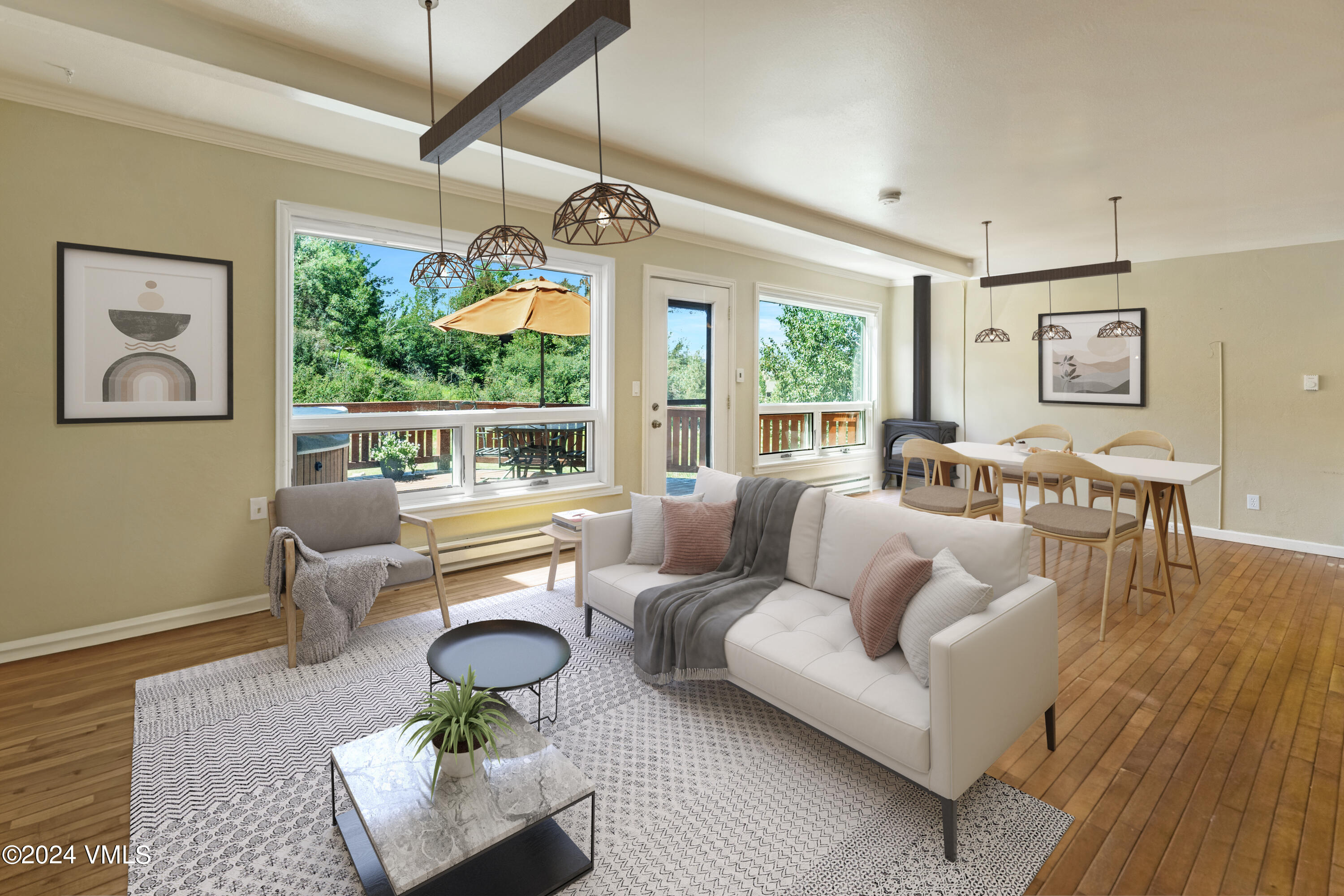 a living room with furniture large window and wooden floor