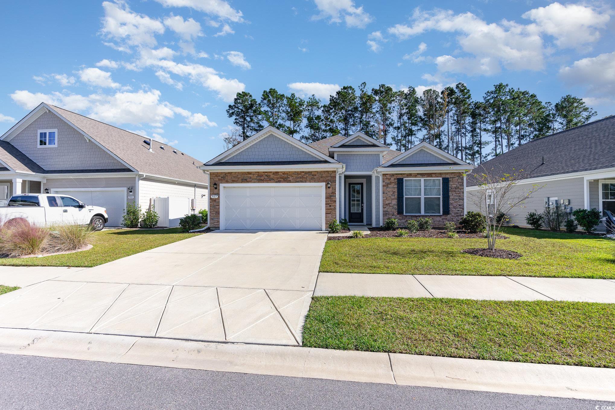 View of front of property with a garage and a fron