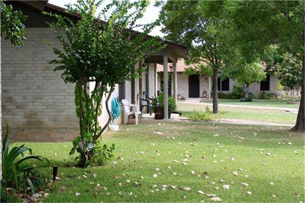 a view of a house with a tree in a yard