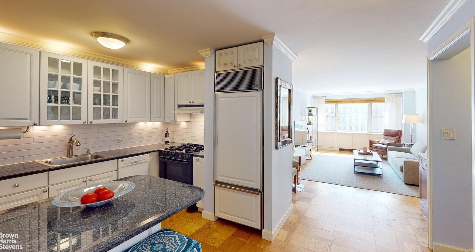 a kitchen with stainless steel appliances granite countertop a refrigerator and a sink