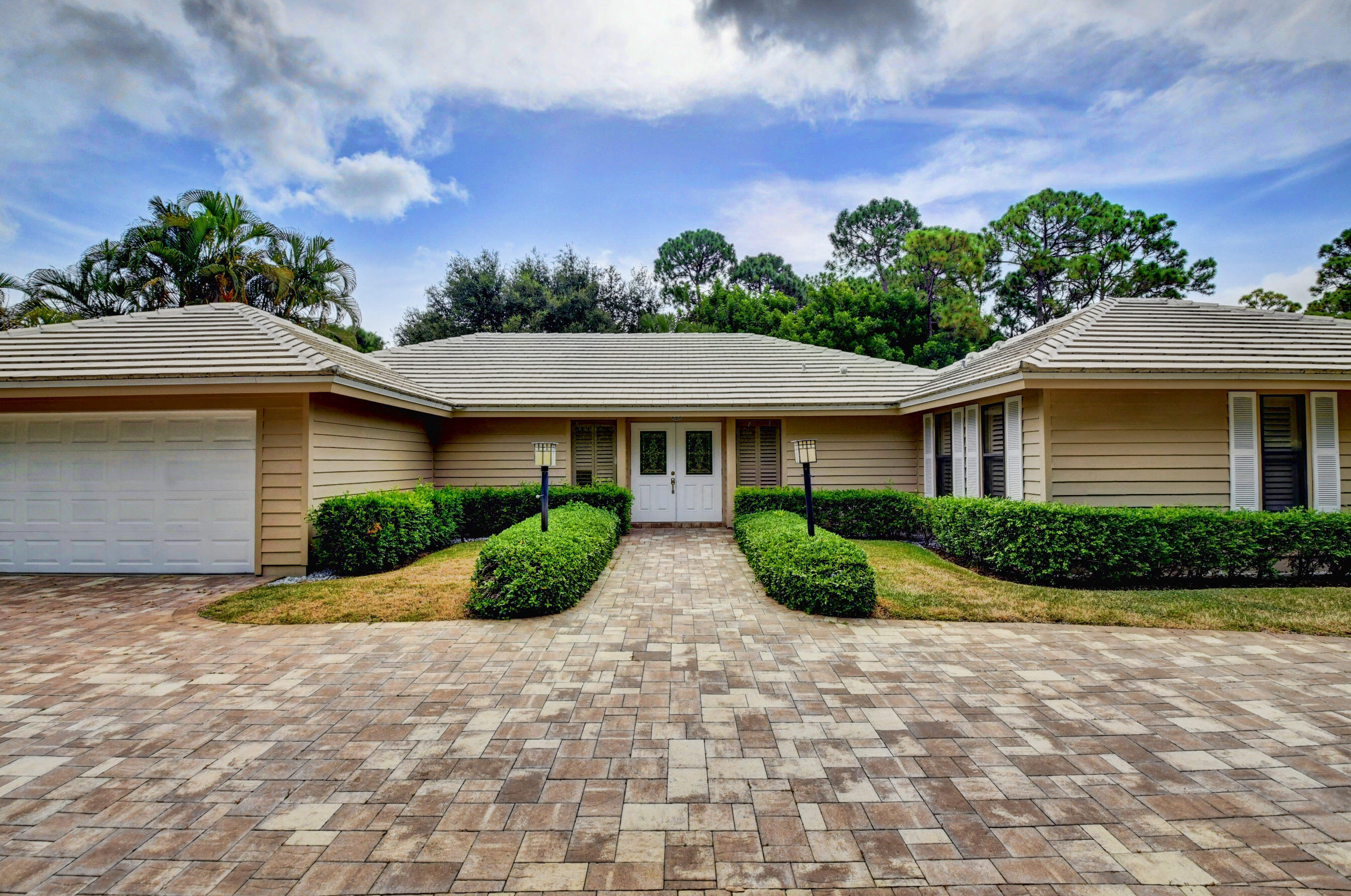 a front view of house with yard and green space