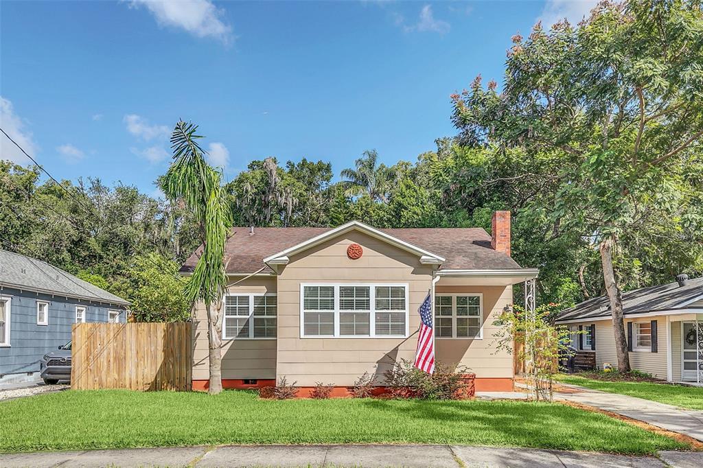 a front view of a house with a yard and trees