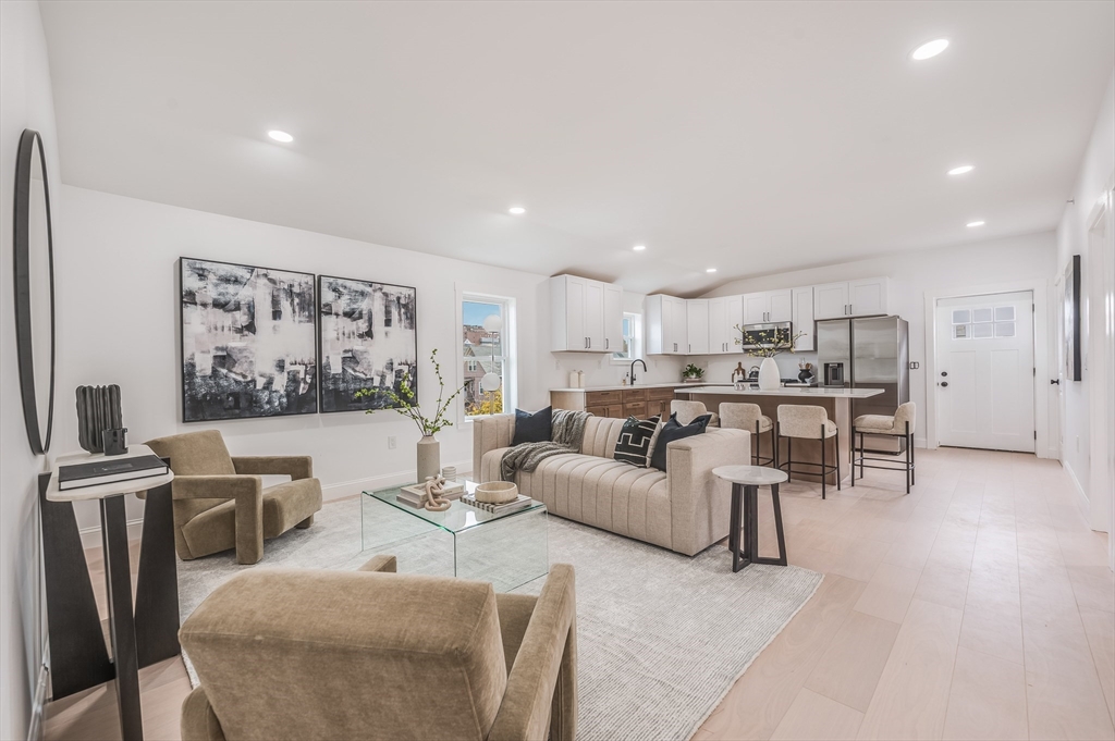 a living room with furniture and kitchen view