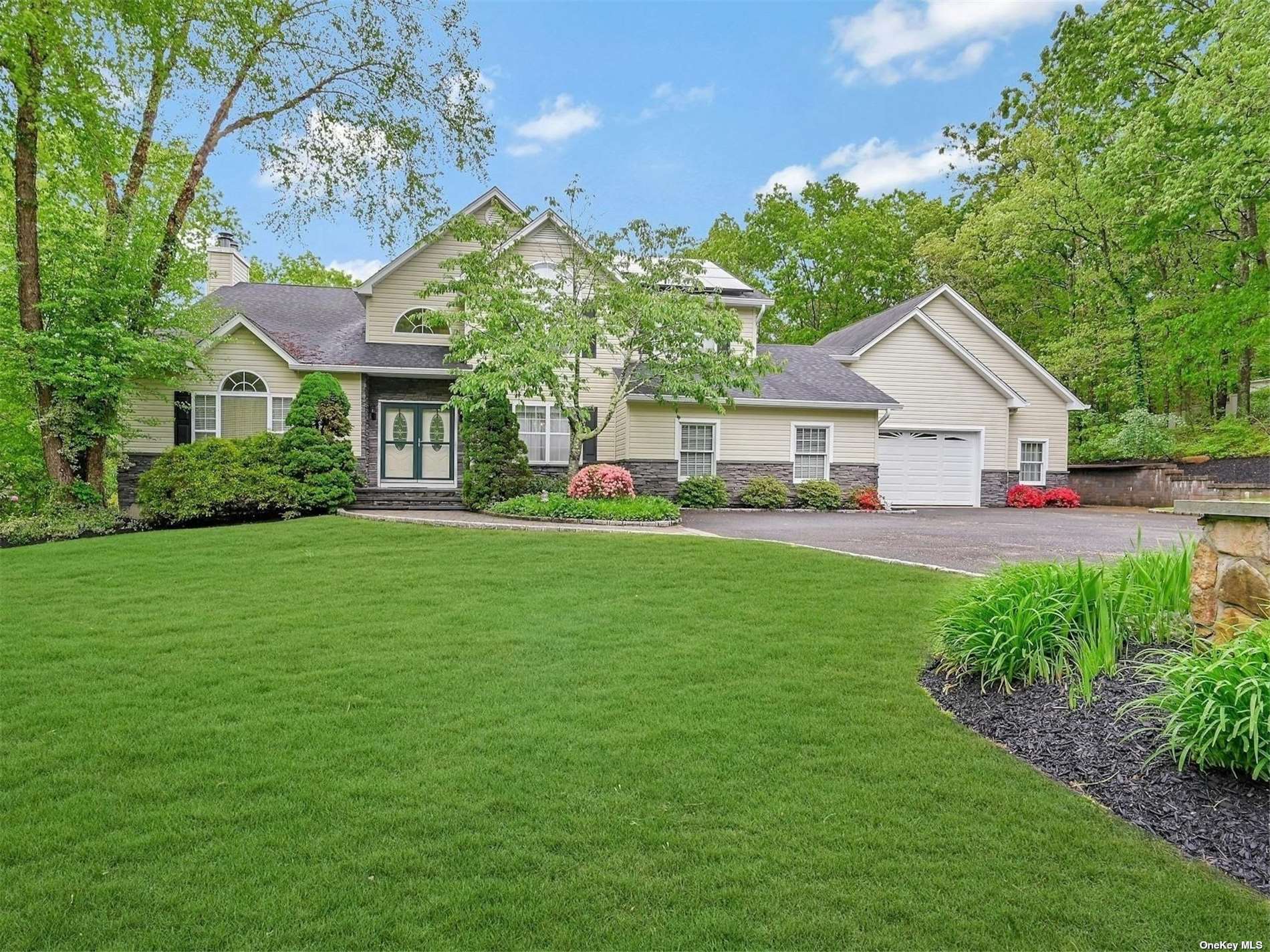 a front view of house with yard and green space