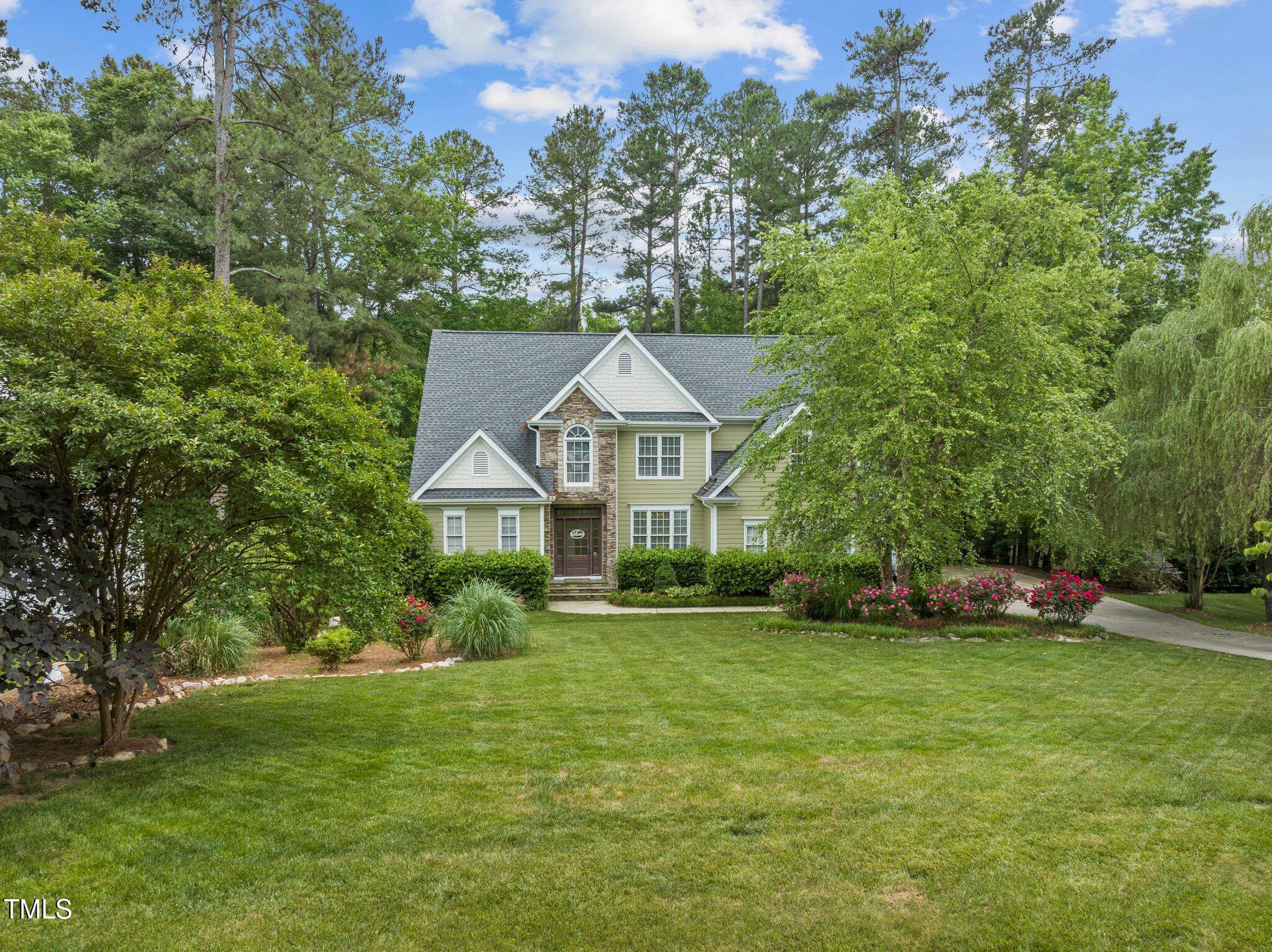 a front view of a house with a garden