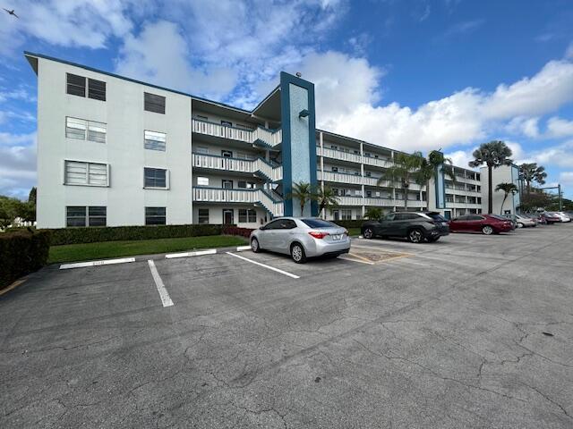 a view of building with cars parked in front of it