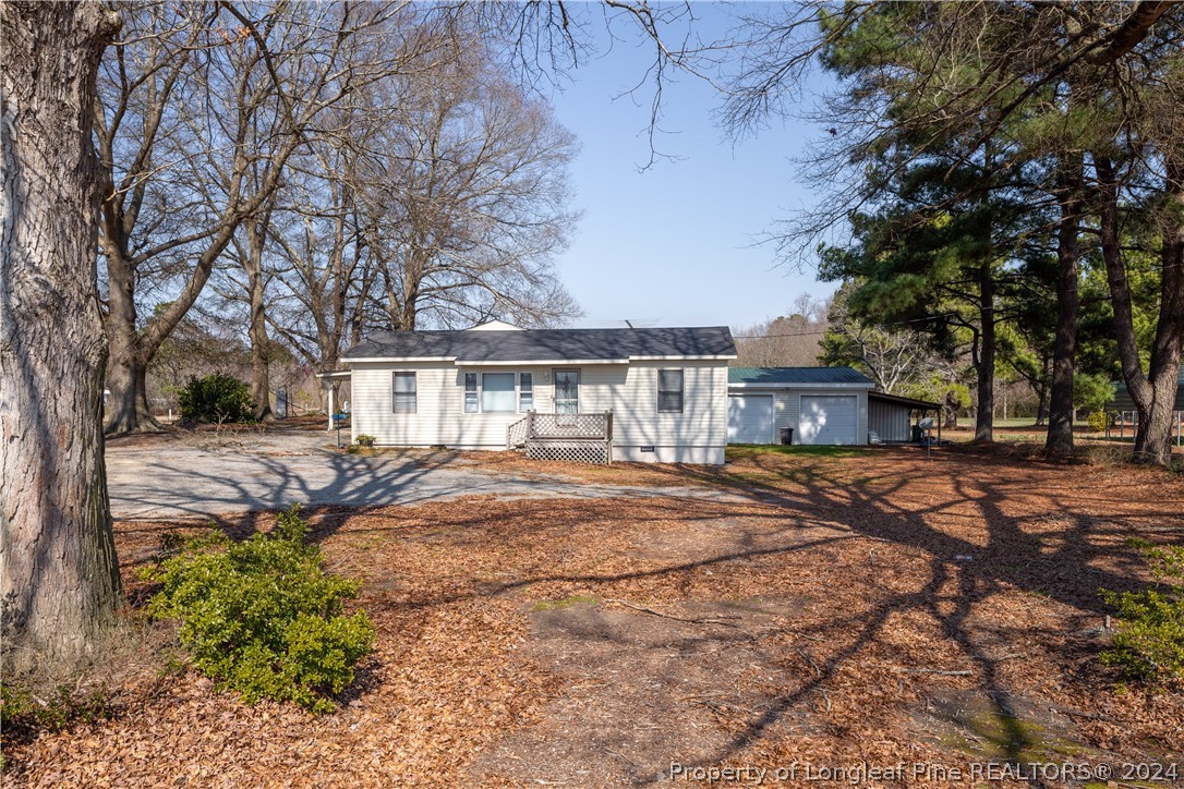 a view of house with outdoor space and trees