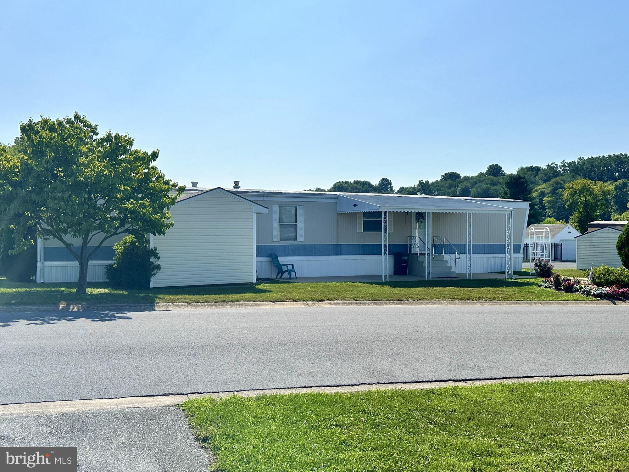 a front view of a house with a yard and a garage