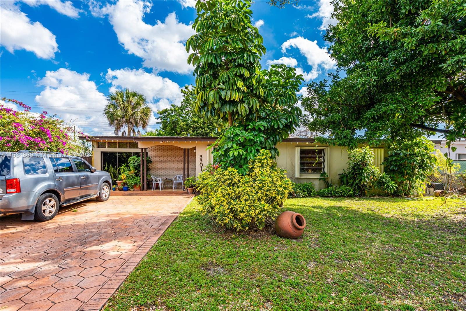 a front view of a house with garden