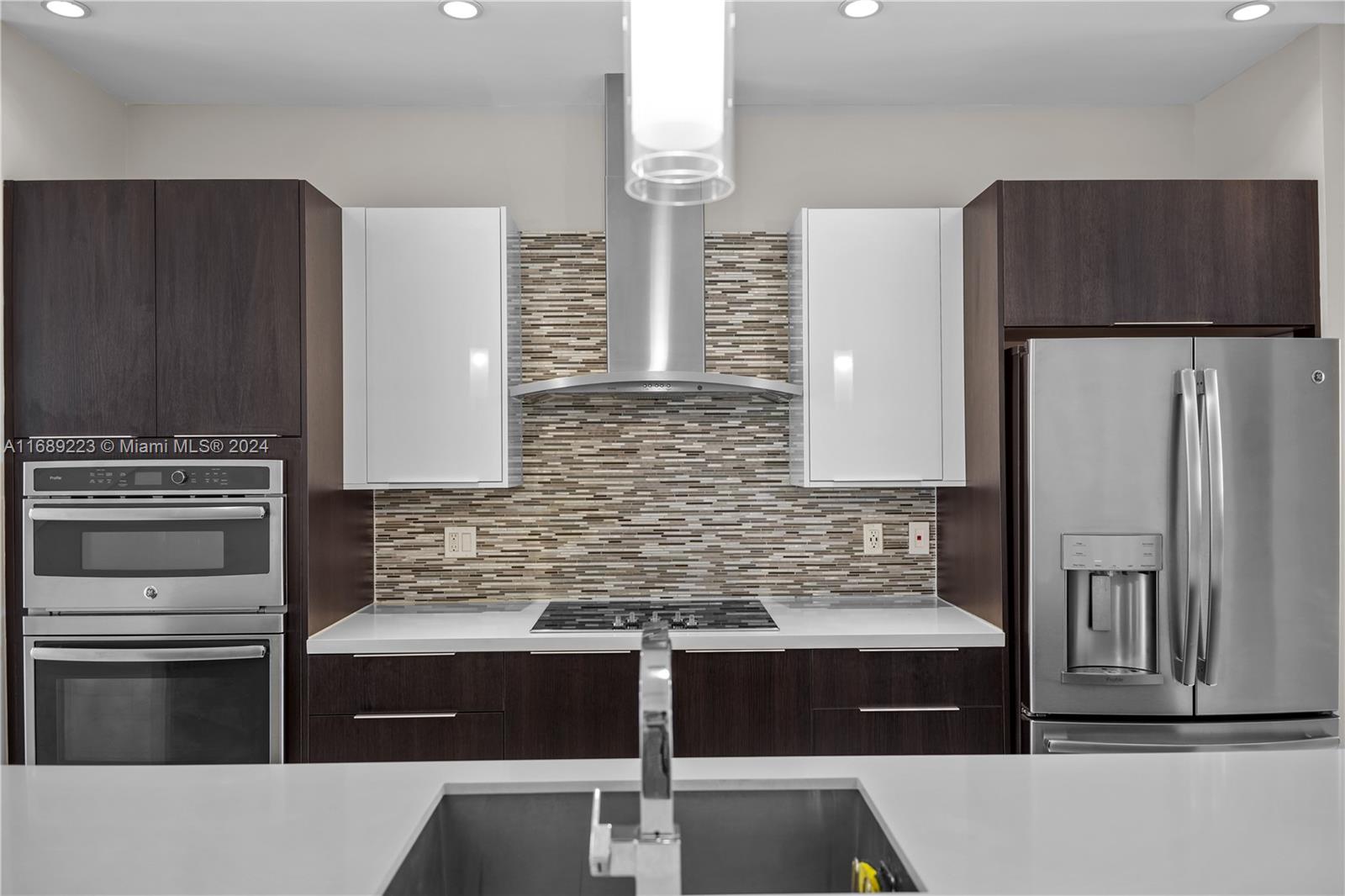 a kitchen with stainless steel appliances wooden cabinets and a counter top space