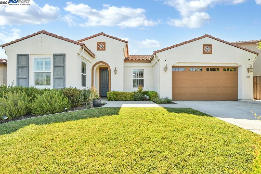 a front view of a house with a yard and garage