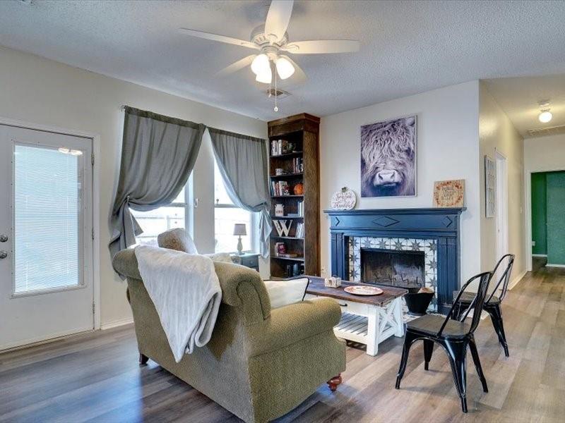 a living room with furniture and a fireplace