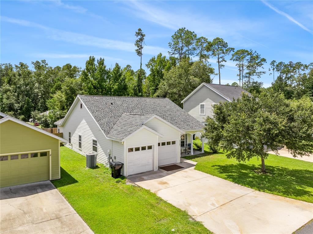 an aerial view of a house with a yard