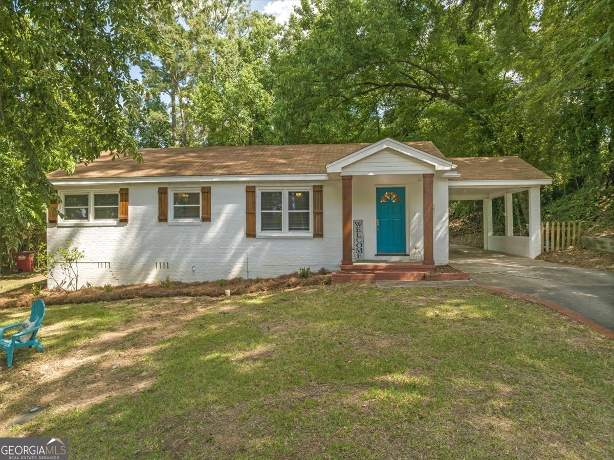 a front view of a house with a garden