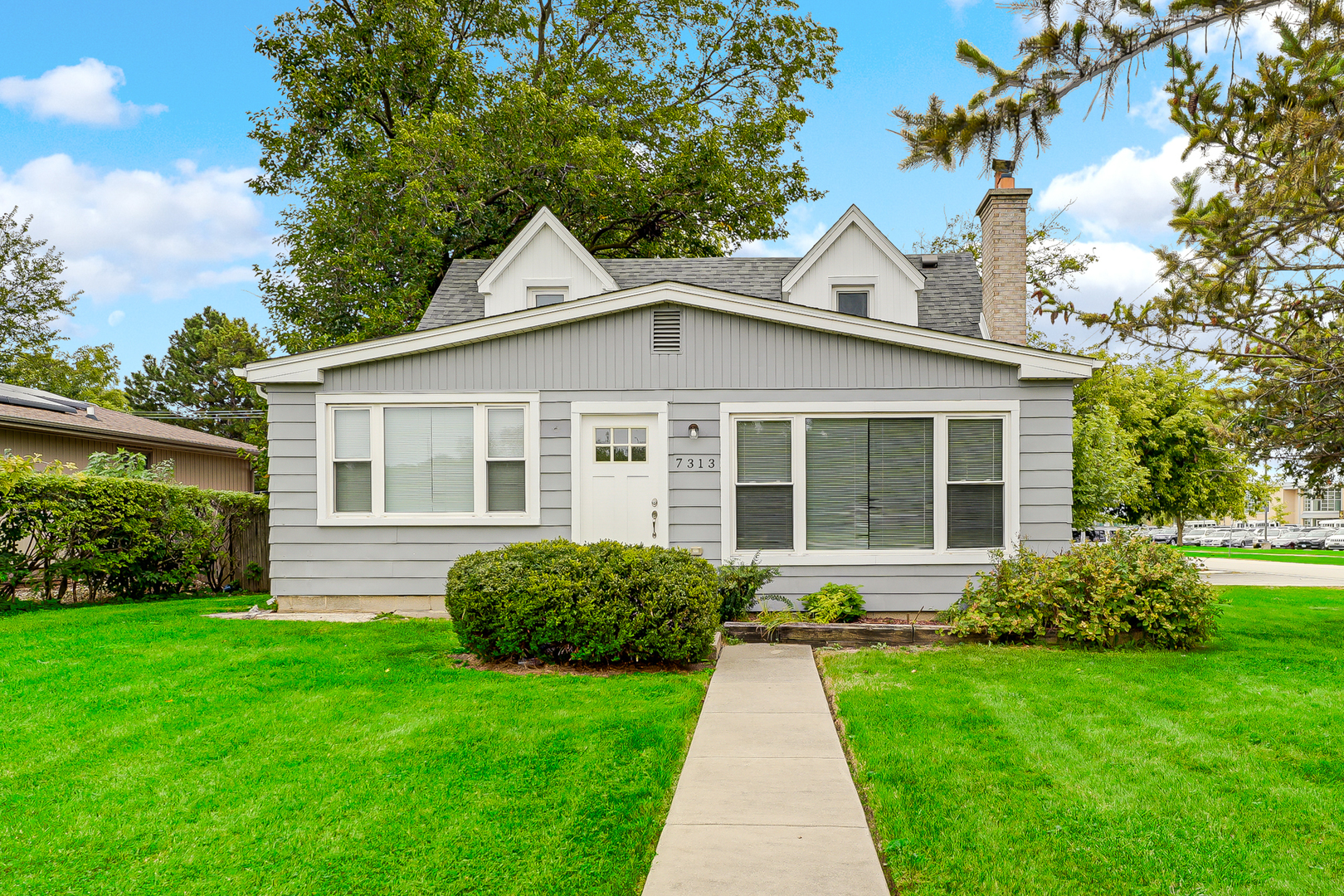 a front view of a house with a yard and porch