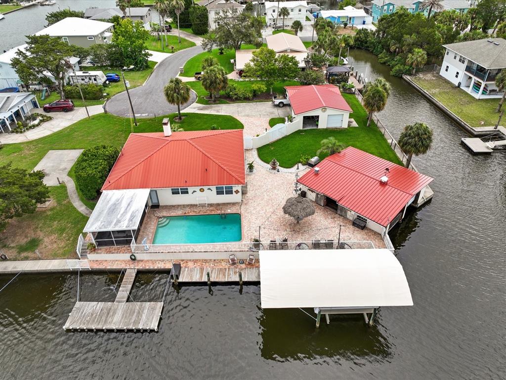 an aerial view of a house with outdoor space and pool