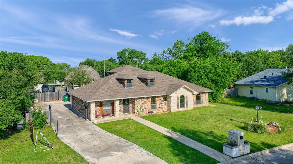 a aerial view of a house next to a yard