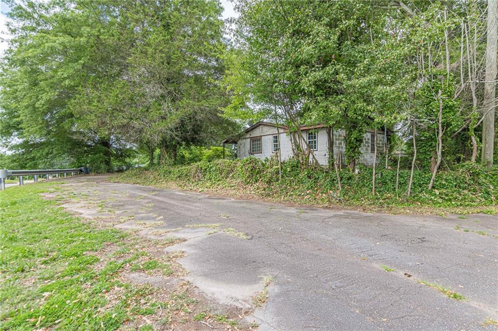 a view of backyard of house with green space