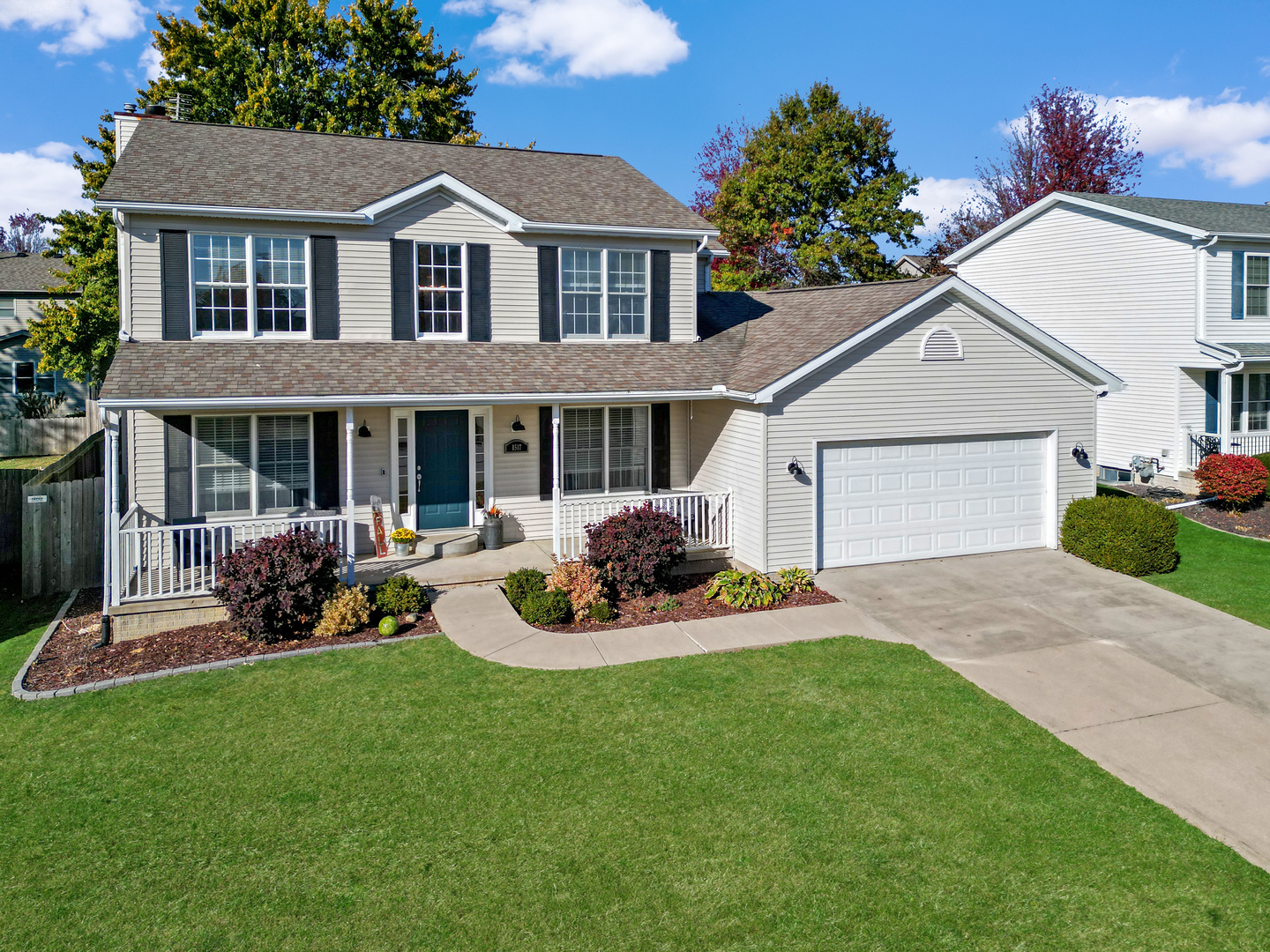 a front view of a house with a garden and patio