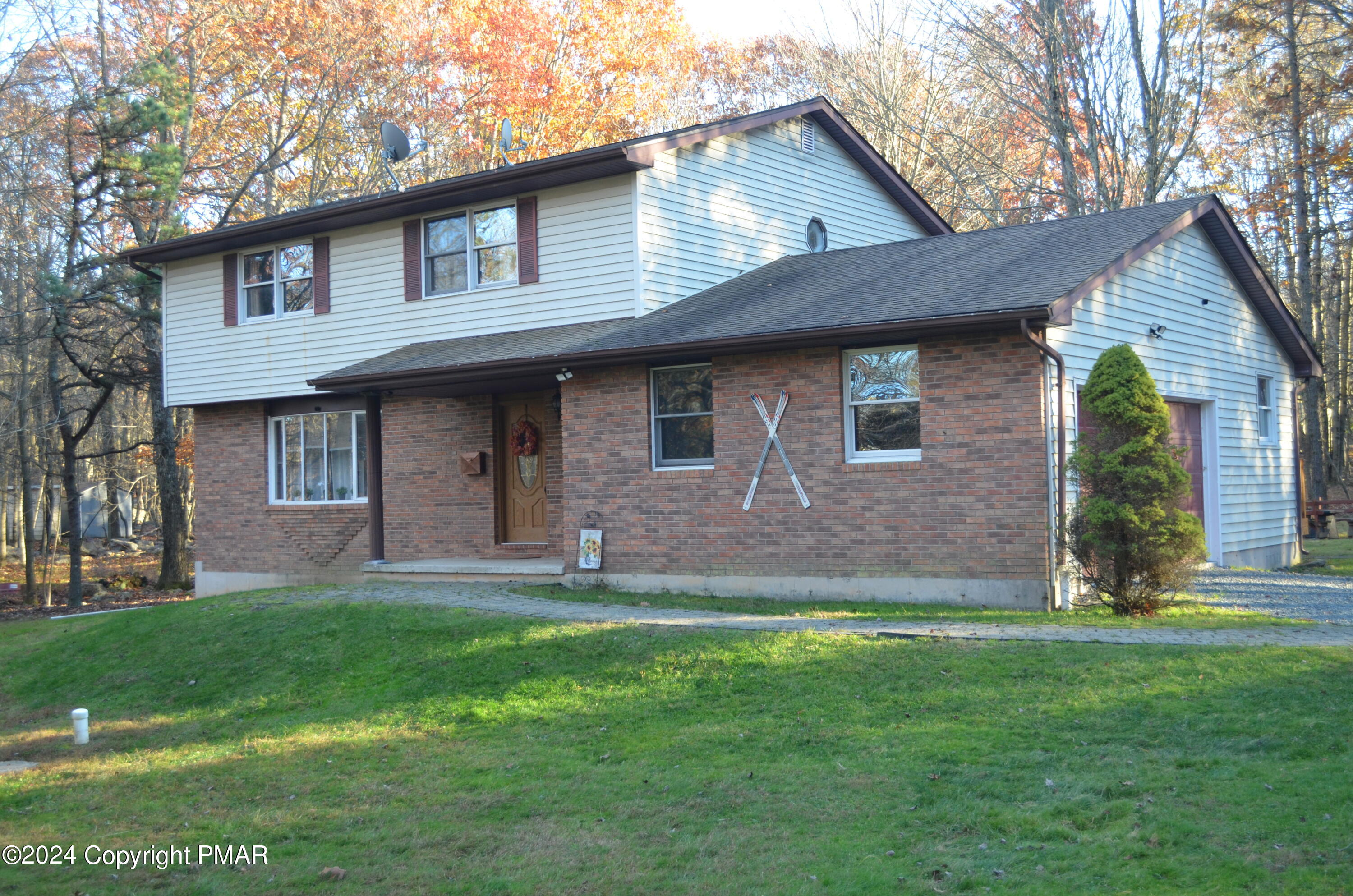 a front view of a house with a garden