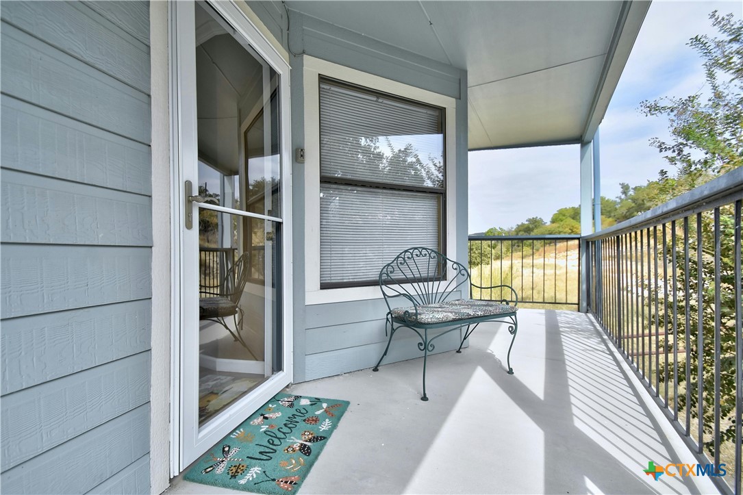 a balcony with table and chairs