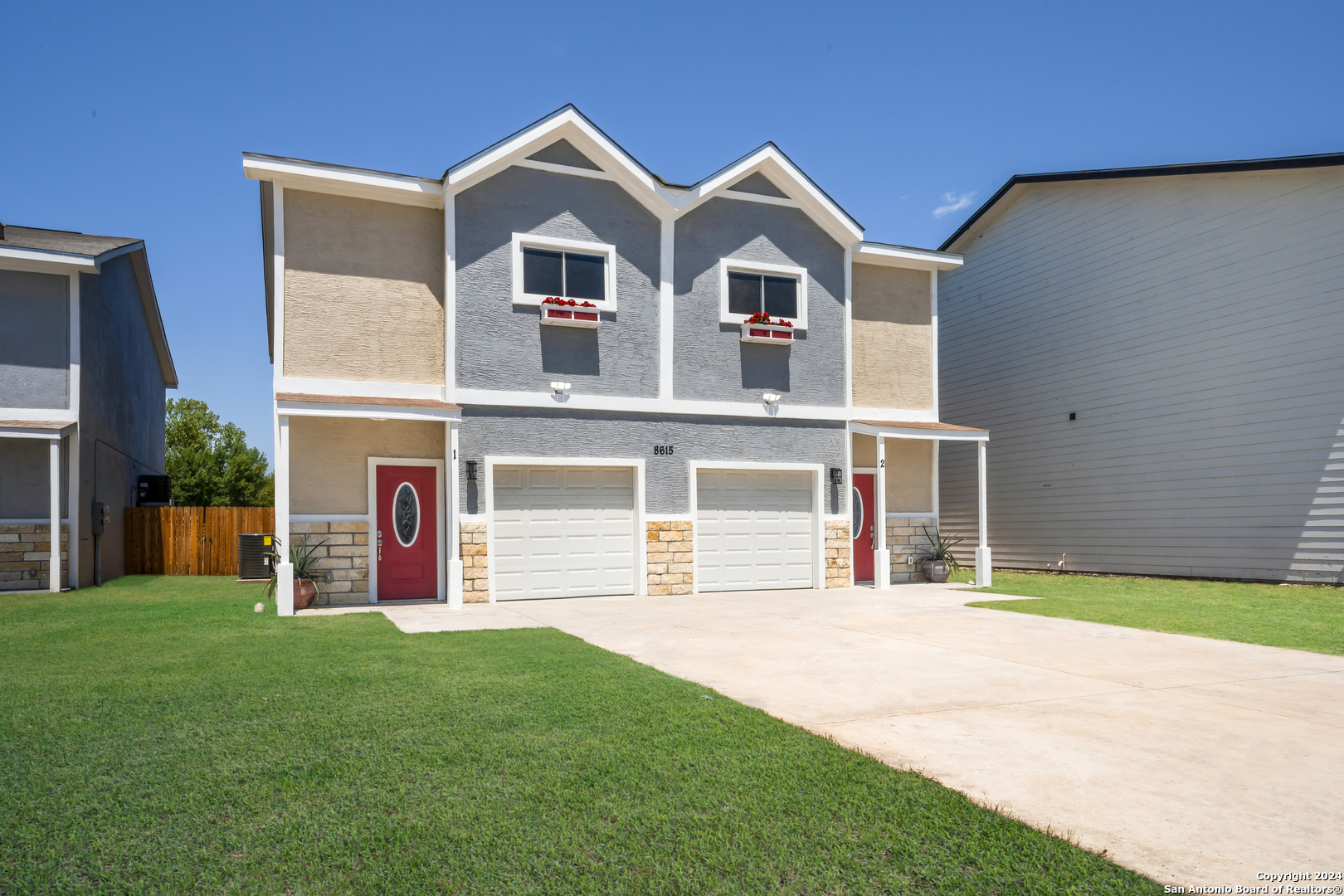 a view of a house with a yard and garage