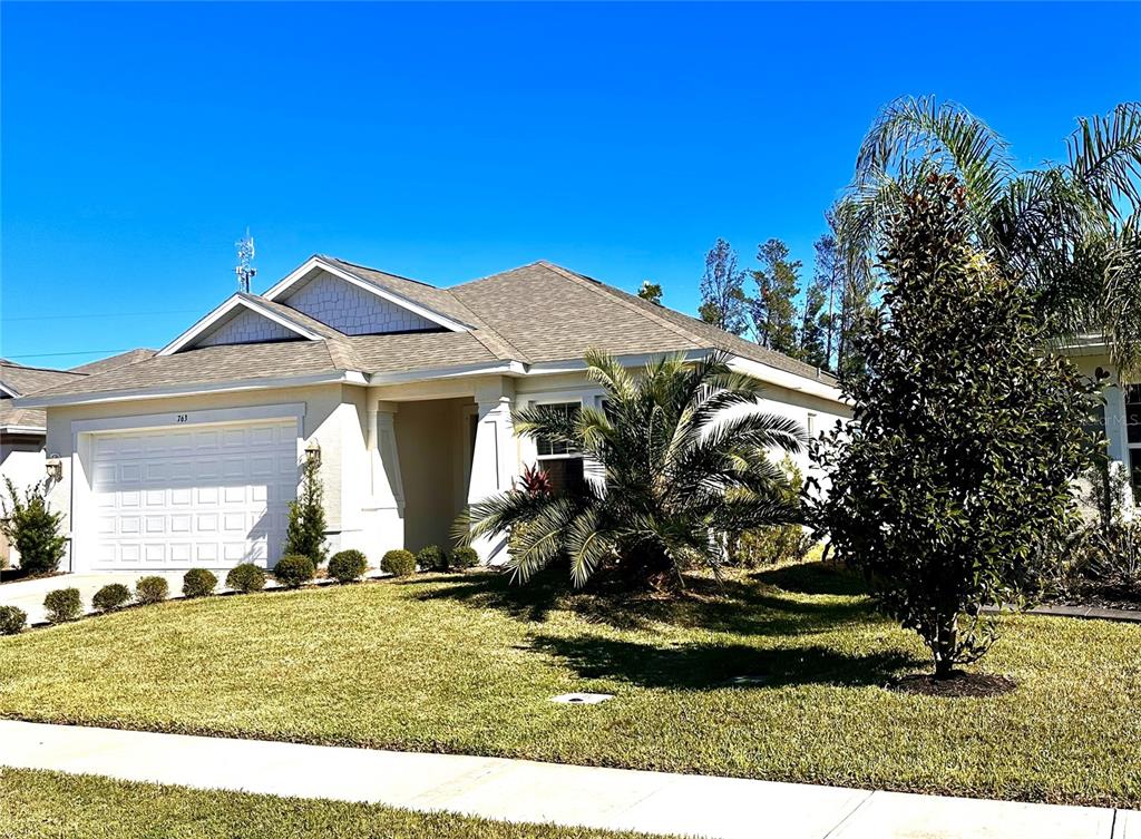 a front view of a house with a yard