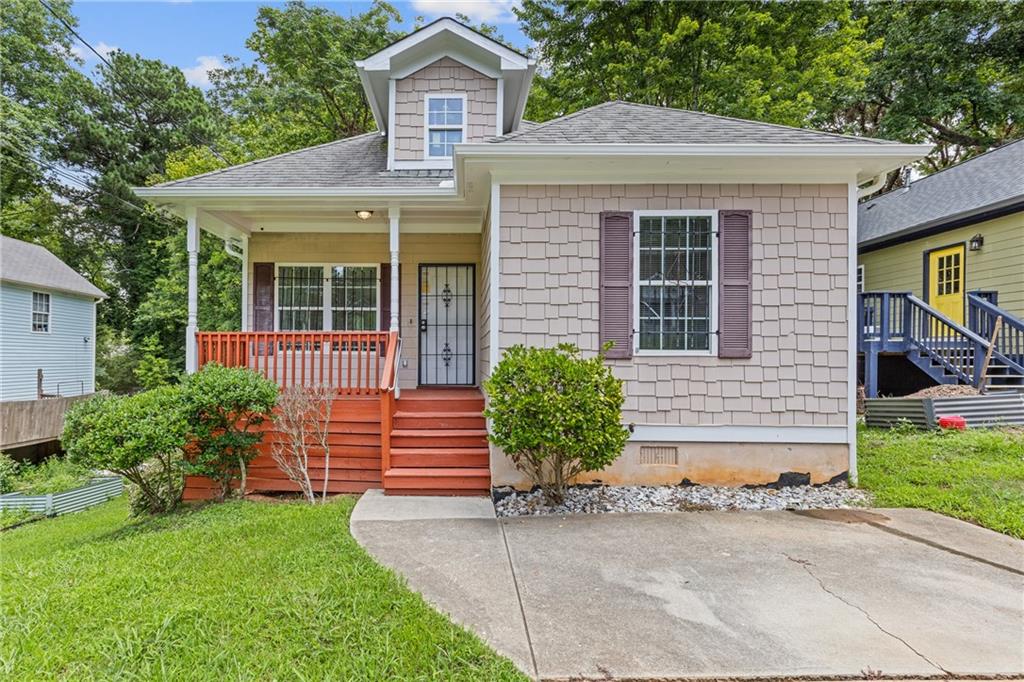 a front view of a house with a yard and outdoor seating