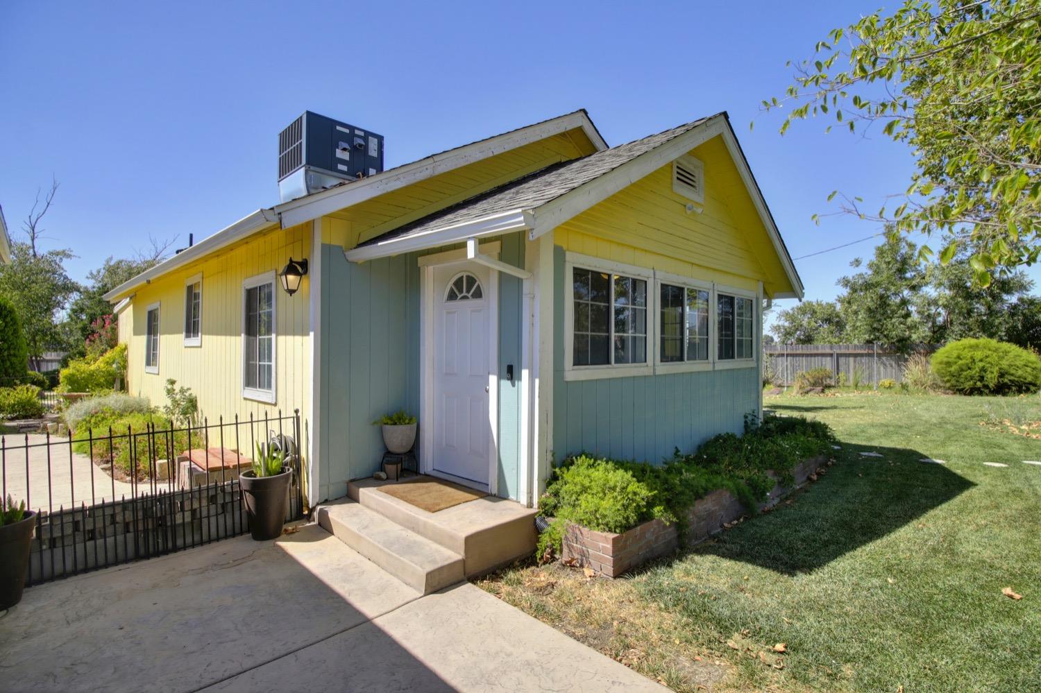 a front view of a house with a garden