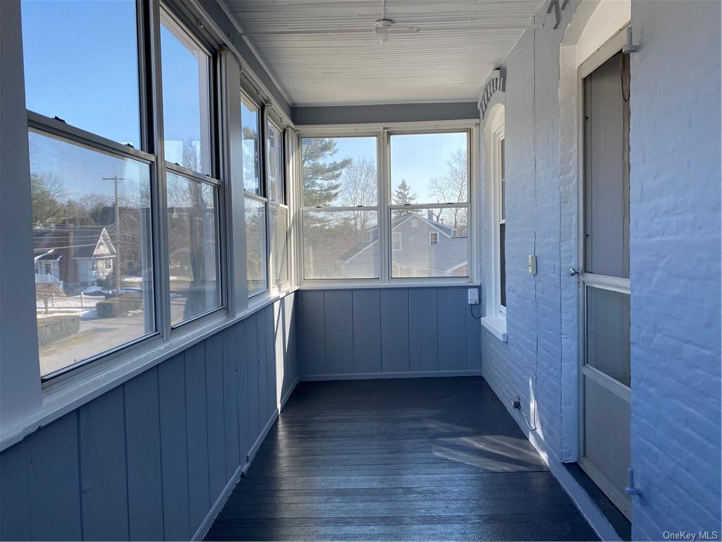 a view of room with window and wooden floor