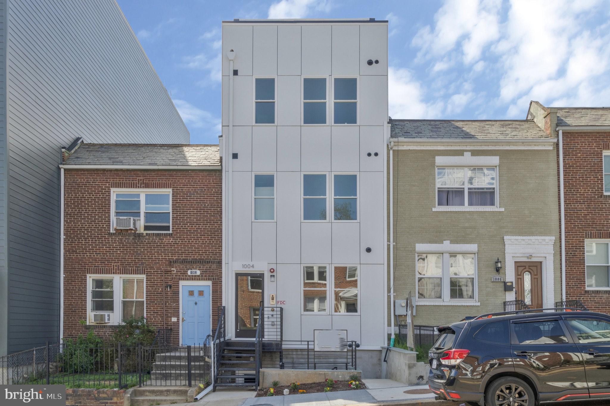 a front view of a residential apartment building with a yard