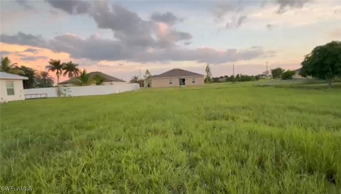 a view of a big yard with a house